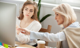 Senior,And,Young,Female,Colleagues,Discuss,Online,Project,Look,At