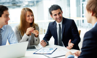 Image,Of,Business,Partners,Discussing,Documents,And,Ideas,At,Meeting