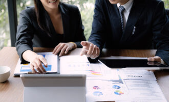 Businessman,And,Accountant,Checking,Data,Document,On,Digital,Tablet,For