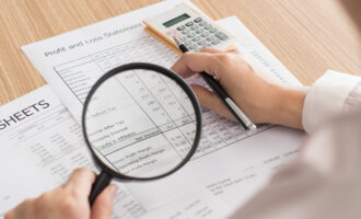 Auditor,Checking,Financial,Statement,With,Magnifying,Glass.,Audit,Concept.,Top